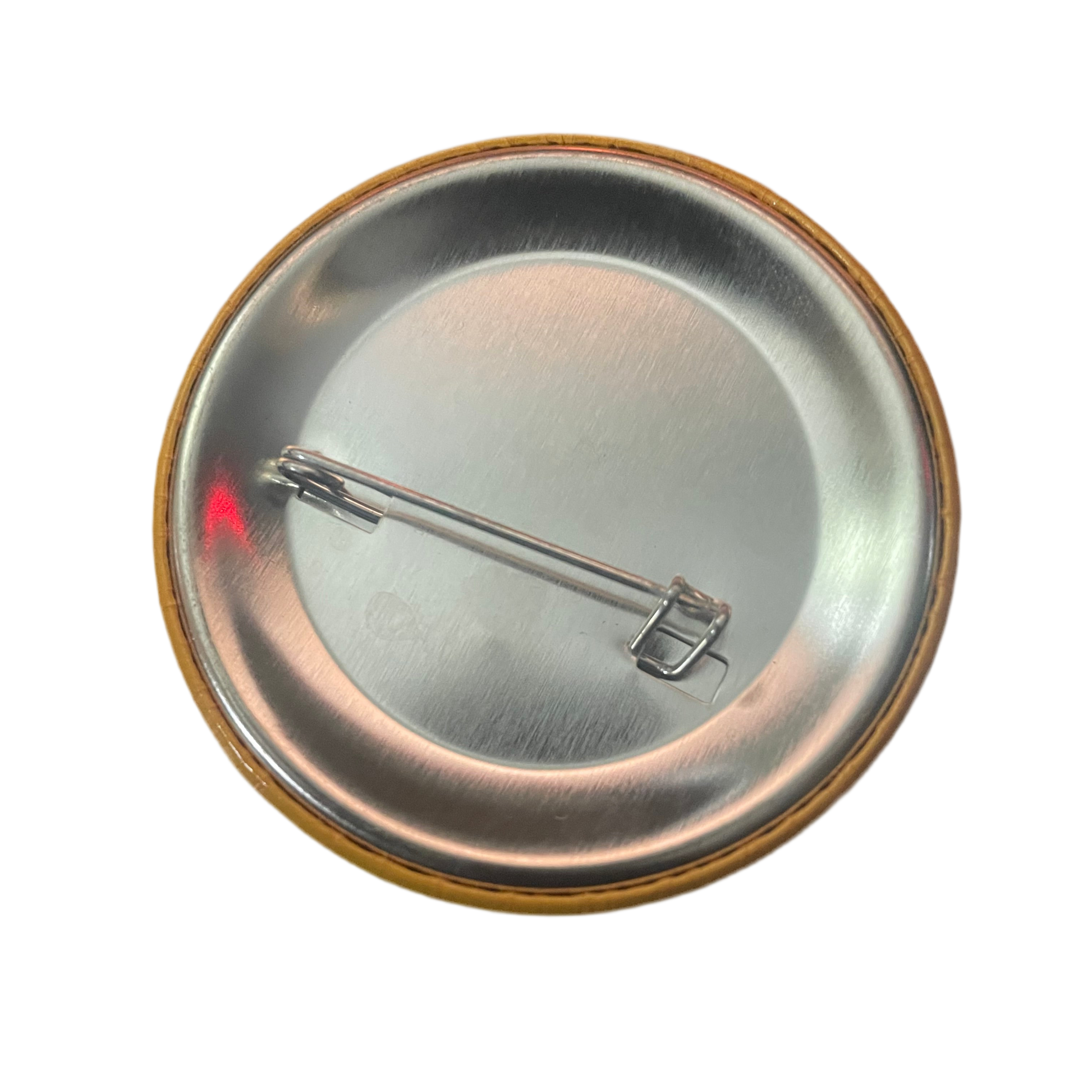Metallic button badge with a pin on a white background